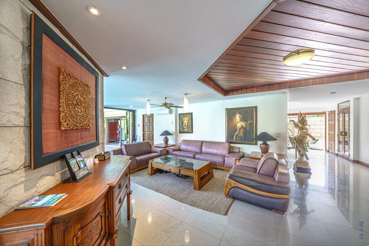 Bright living room with purple sofas and Thai decor at The Himmaphan Phuket villa.